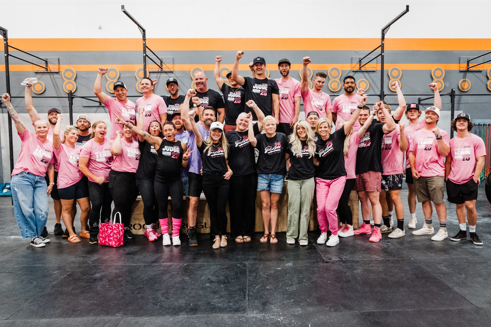 Battle of the Breasts community group celebrating together in pink and black event shirts